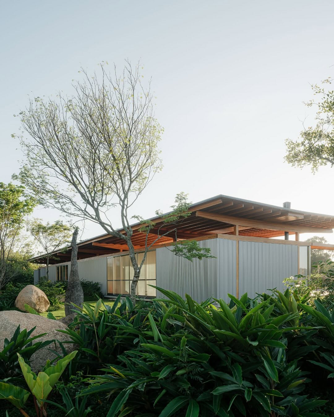 Casa Itupeva is conceived as an extension of the landscape, emerging from dense vegetation, exposed stones, and the site’s natural slope. Its architecture is organized into a light timber pavilion above, for the couple’s daily life, and a grounded concrete volume below, embedded in the terrain for the family’s suites and pool. The design emphasizes honest materials, passive environmental strategies, such as a double roof for thermal efficiency, and spacious covered areas that blur interior and exterior. Repositioned rocks, water, wood, and concrete define a home that is both rooted in place and shaped by its natural surroundings.

_project: Casa Itupeva
_architecture: UNA MUNIZVIEGAS 
_images: Pedro Kok @kokpedro 
_drone images: Rodrigo Fonseca
_location: Itupeva, Brazil

——

@architecture_hunter is a non-traditional media that inspires, informs, and entertains a worldwide audience of over 3 million design enthusiasts.

🔎 get published: architecturehunter.com/register
🎥 watch & read: architecturehunter.com
🏆 follow: @architecture_hunter_awards
🏷️ tag #architecture_hunter to be hunted