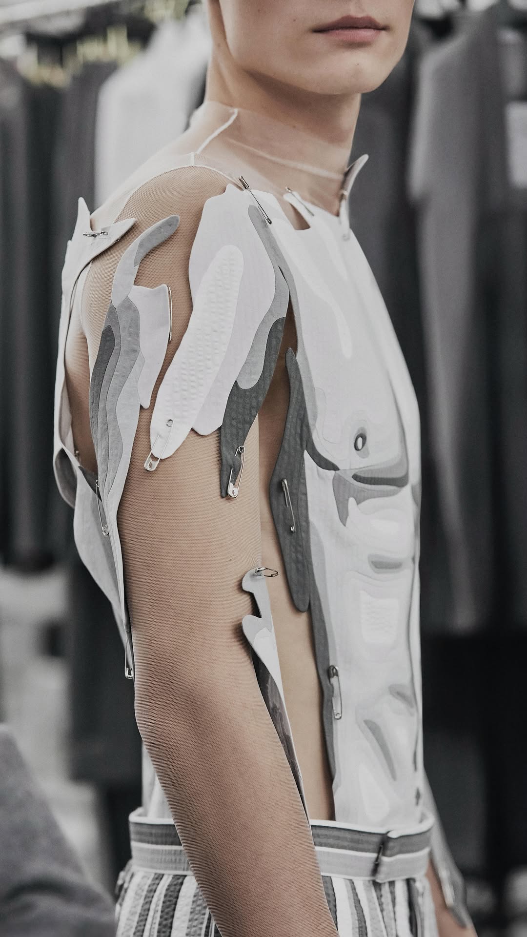 … in orbit … 
thom browne spring 2026 collection. 

shane wears a sheer tulle bodysuit embroidered with mixed-size red, white and blue bicone and flatback crystals with lurex thread, mixed opaque and clear clustered cut beads, textured micro sequins, and looped clear cut beads, to form a torso artwork paired with a knee-length pencil skirt with lenticular shifting artwork from red, white and blue stripes to an image of crossed legs and hector 4-bar platform boots in red nubuck and navy suede.

nickita wears sheer tulle bodysuit with an intarsia men’s torso in mixed shades of grey cotton seersucker with a pleated skirt in grey and white shadow stripe seersucker with self tipping and 4-bar saddle knee-high boots in light grey and white nubuck.

amine wears a sheer tulle bodysuit embroidered with mixed-size, layered sequins, topped with clear seed beads to form a rainbow torso artwork with backstrap shorts in red, white and blue classic stripe seersucker and 4-bar saddle knee-high boots in navy and white nubuck.

anyiel wears a sheer tulle bodysuit embroidered with silver looped cut beads, standing layered sequins, textured micro sequins, rectangle sequins with lurex and bugle beads, mixed clustered cut beads and crystals, to form a body artwork, paired with an ankle-length pencil skirt embroidered with silver rectangle sequins in a vertical and horizontal formation mixed with bugle beads to form a classic repp stripe. anyiel walks in 105mm longwing brogues in dark grey and crystal strass.
#thombrowne #thombrowness26