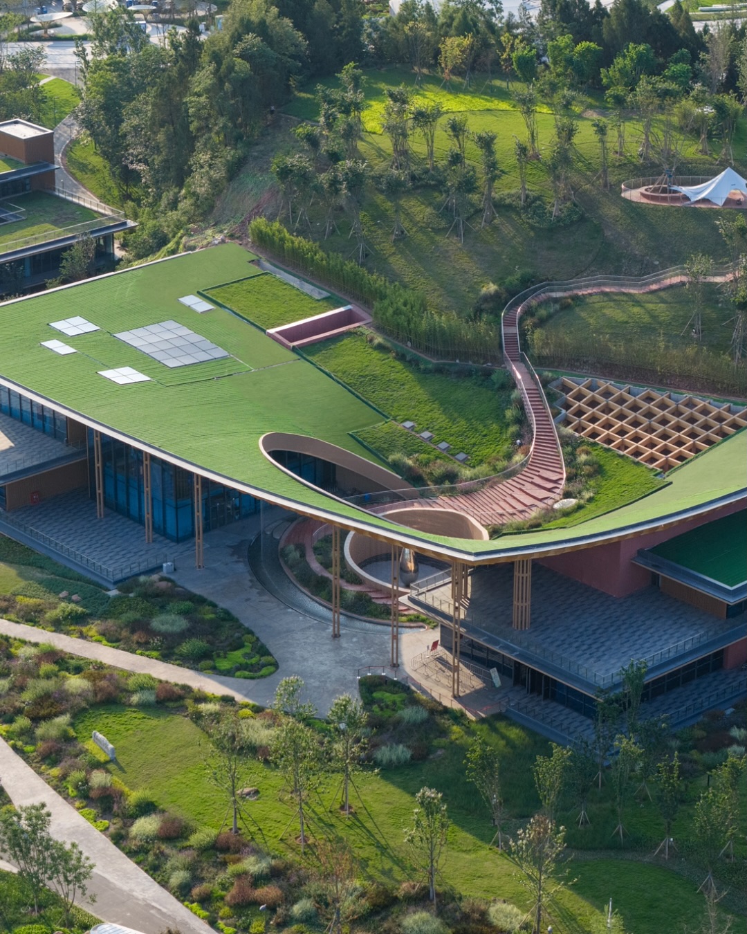 The Friendship Pavilion for the 2024 Chengdu International Horticultural Exposition stands as a finely tuned expression of regional culture and sustainable modern architecture. Nestled amid the gently sloped terrain of Chengdu’s new development zone, the pavilion integrates sweeping curvilinear forms that evoke local tea-house courtyards, lotus ponds and bamboo groves. Its low-profile roof gently merges with landscape, while glazed walls and open courtyards invite fluid interaction between interior and exterior. Building materials and systems are chosen with environmental sensitivity in mind: recycled steel, locally sourced stone and timber references, and rain-water harvesting all contribute to a reduced carbon footprint. The design radiates hospitality, inviting visitors into a space of tranquillity and communal connection that reflects Chengdu’s cultural ethos of gathering and shared ritual.

_project: Chengdu International Friendship Pavilion
_architecture: Sichuan Provincial Architectural Design and Research Institute CO., LTD 
_location: Chengdu, Sichuan
_images : @archexist 

——

@architecture_hunter is a non-traditional media that inspires, informs, and entertains a worldwide audience of over 3 million design enthusiasts.

🔎 get published: architecturehunter.com/register
🎥 watch & read: architecturehunter.com
🏆 follow: @architecture_hunter_awards
🏷️ tag #architecture_hunter to be hunted