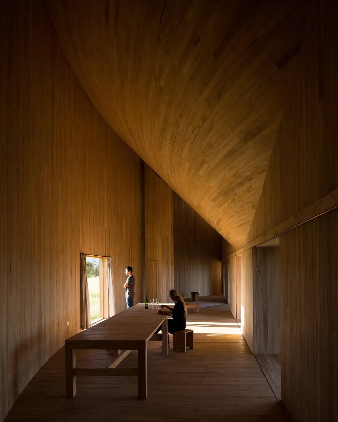 Rode House by @pezovonellrichshausen rises dramatically above the meadows of Chile’s Chiloé Island, its asymmetrical form born from the intersection of a cone and a cylinder. The resulting geometry creates two mirrored rooms, one bathed in warm sunlight, the other in cooler shade, connected by a central courtyard sheltered from the island’s rain and wind. Built entirely from local timber, the structure’s forty-five rigid frames and shingled conic roof draw on Chiloé’s artisanal carpentry traditions, blending monumental presence with the delicate simplicity of vernacular craft.

_project: Rode House
_architecture: Pezo von Ellrichshausen | @pezovonellrichshausen 
_photographer: Pezo von Ellrichshausen | @pezovonellrichshausen 
_location: Chonchi, Chile

——

@architecture_hunter is a non-traditional media that inspires, informs, and entertains a worldwide audience of over 3 million design enthusiasts.

🔎 get published: architecturehunter.com/register
🎥 watch & read: architecturehunter.com
🏆 follow: @architecture_hunter_awards
🏷️ tag #architecture_hunter to be hunted