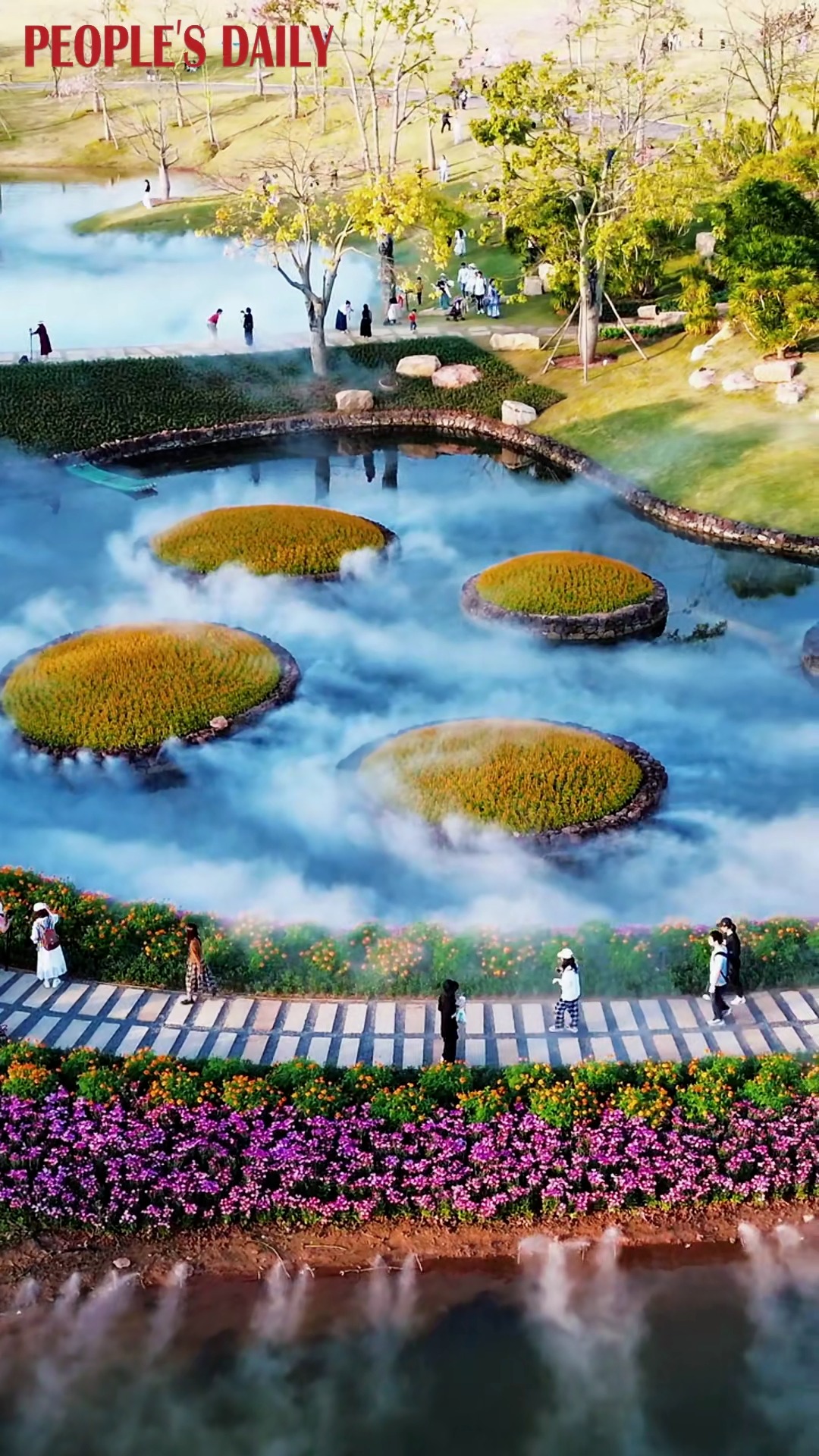 Colorful #blossoms graced by water mist add vibrancy to a meticulously arranged #garden, inviting visitors to take a leisurely walk at the Qingxiu Mountain scenic area in Nanning, south China’s Guangxi. #beautifuldestinations