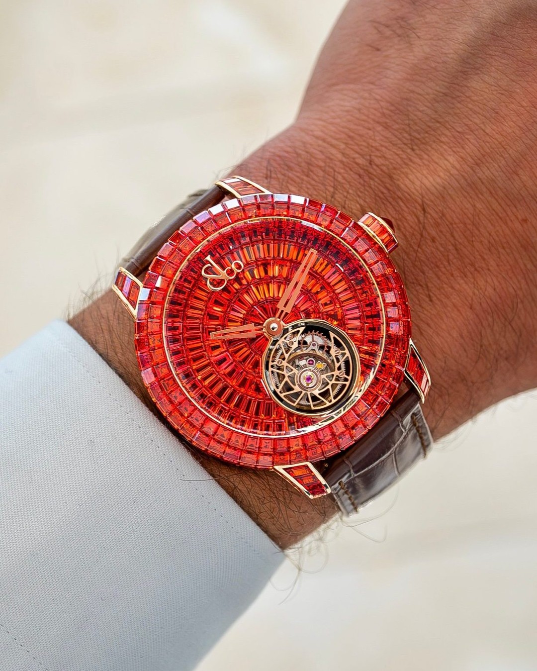 A masterpiece of color and complication, the Caviar Tourbillon Orange Sapphires radiates with 224 invisibly set baguette-cut sapphires on its 47mm 18K rose gold case, complemented by a rose-cut sapphire crown. The dial continues the spectacle with 130 hand-cut baguette sapphires arranged in a flawless gradient of light.

At its heart, a flying tourbillon brings the watch to life—an ode to motion, craftsmanship, and rarity. Produced in a strictly limited series of 18 pieces.

47-mm rosegold case
710 baguette-cut orange sapphires (36.77 ct.) invisibly-set
Self-winding movement set with diamonds
Flying tourbillon

#Jacobandco #Inspiredbytheimpossible
